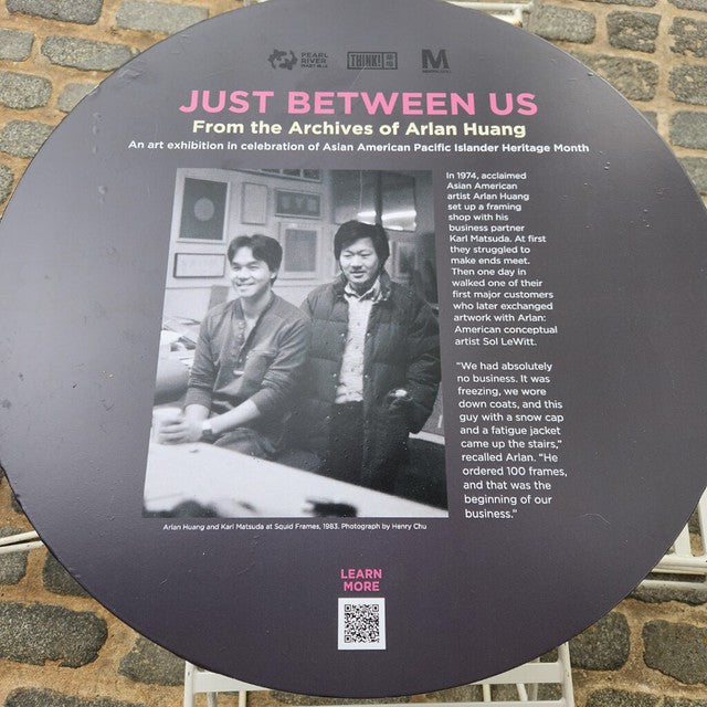 A table from the "Just Between Us" installation in the Meatpacking district. Photo features artist Arlan Huang and business partner Karl Matsuda at their framing business, Squid Games.