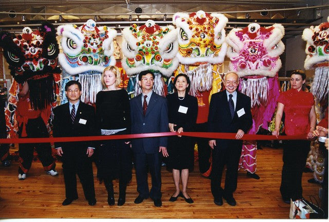 Julia Styles, Mr. and Mrs. Chen in front of lion dancers at grand opening of 477 Broadway location of Pearl River Mart