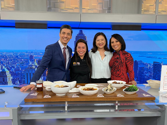 PIX11 news anchor Dan Mannarino, Maxi Lau, Joanne Kwong, PIX11 news anchor Hazel Sanchez in PIX11 studio in front of table of food