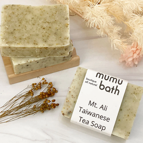 Mumu Bath brand Mt. Ali Taiwanese Tea Soap beside other bars of soap and dried flowers