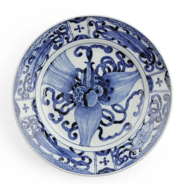 A round ceramic plate with a blue and white hand-painted floral design, photographed from directly above on a white background.