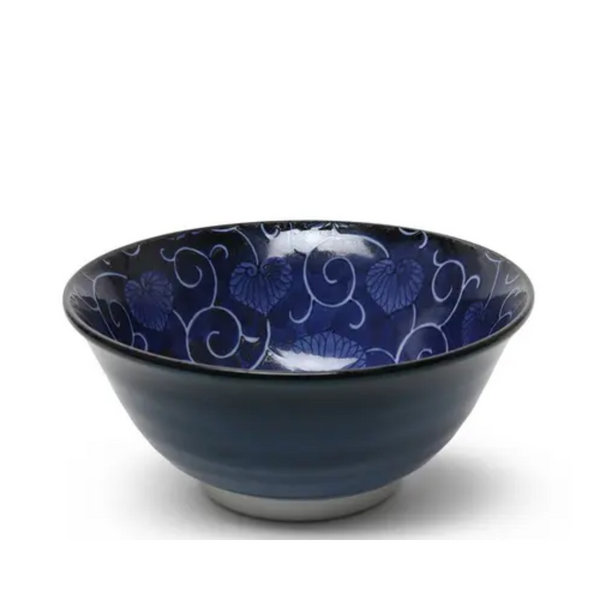 Blue ceramic bowl with floral patterns on a white background