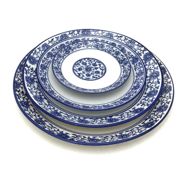 4 round plates in a blue lotus and vine pattern, each in different sizes.