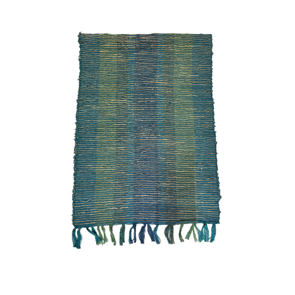 Textured blue and green table runner with fringes on a white background
