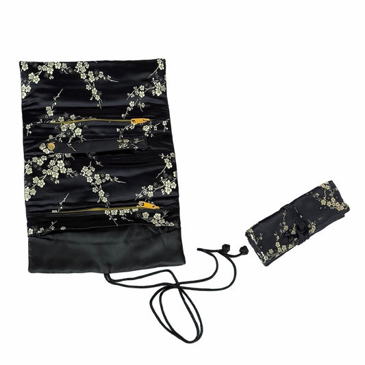 Black brocade jewelry roll with white blossoms