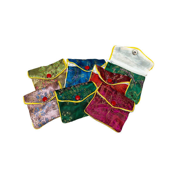 Set of colorful fabric pouches with red buttons on a white background