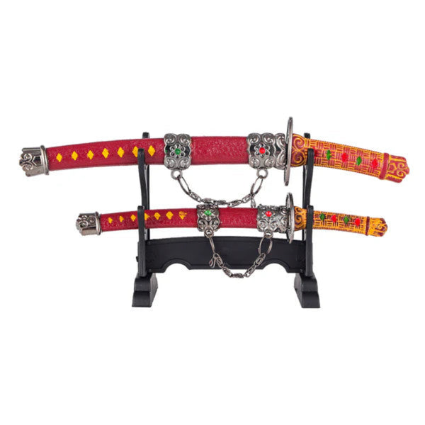 A display stand holds two ornate red-and-orange belts with jeweled silver buckles and dangling chains, arranged horizontally
