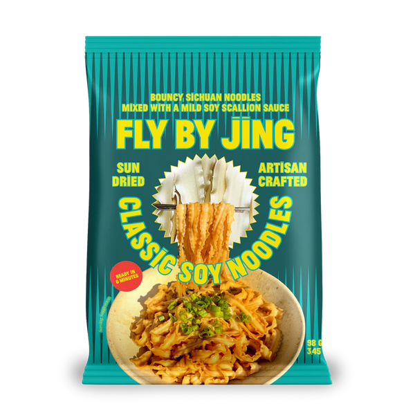 Packaging of Fly By Jing Classic Soy Noodles with teal background and noodle imagery.