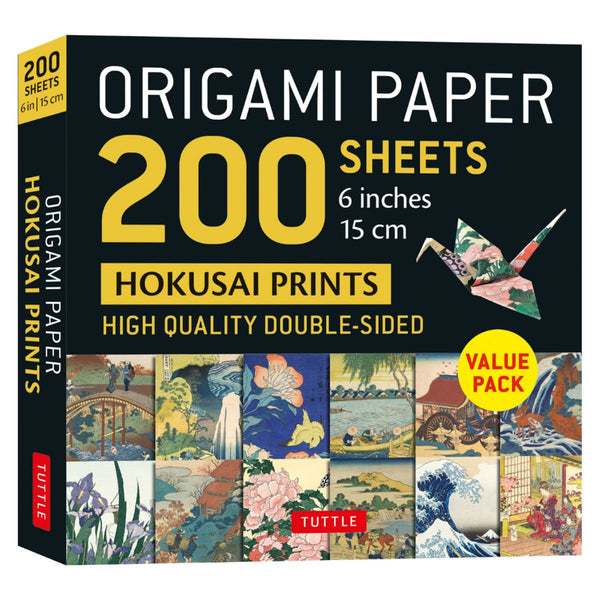 Box of origami paper with Hokusai prints featuring images of various scenes.