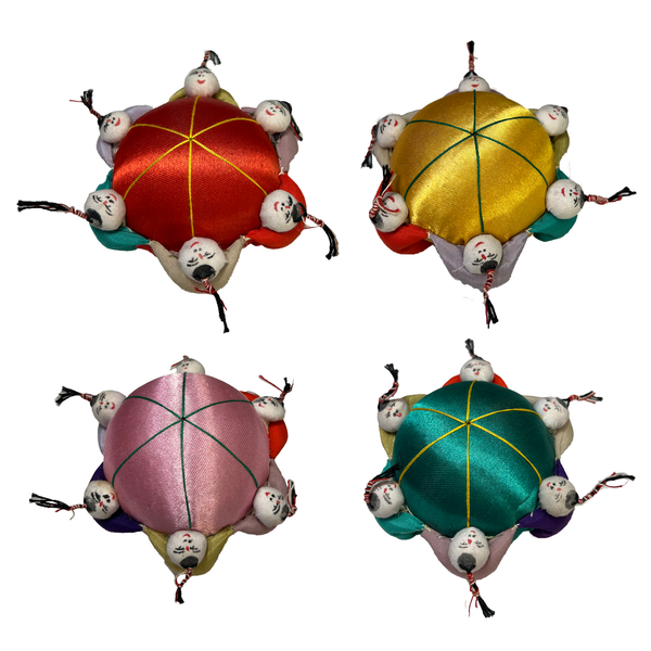 Four Chinese pin cushions in red, yellow, pink, and green