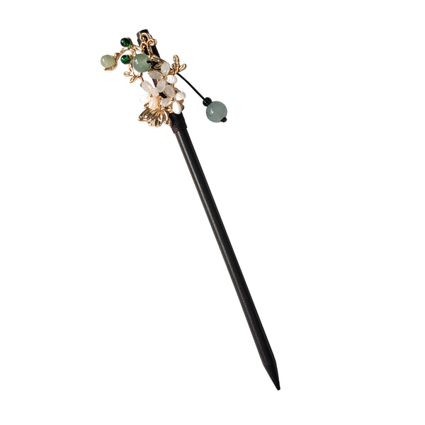 Decorative hairpin with gemstones on a white background