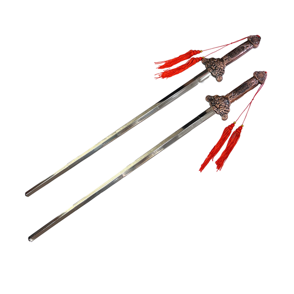 Two decorative swords with ornate handles and red tassels on a white background