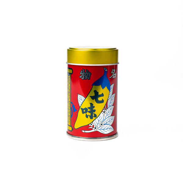 Colorful spice canister with a red label and gold lid on a white background