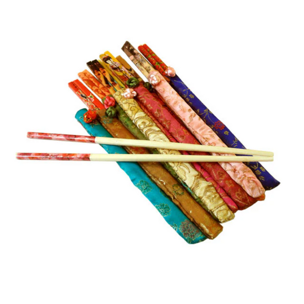 Set of colorful chopsticks with decorative cases on a white background