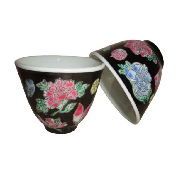 Two ceramic cups with floral designs on a white background