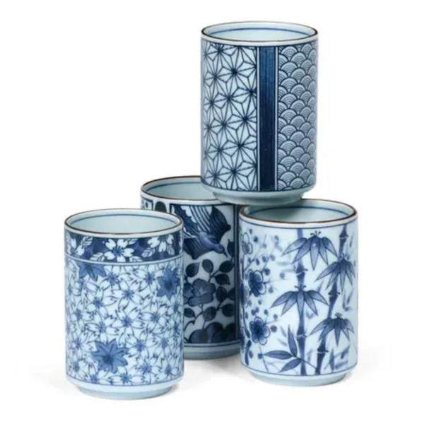 Stack of four blue and white design tea cups