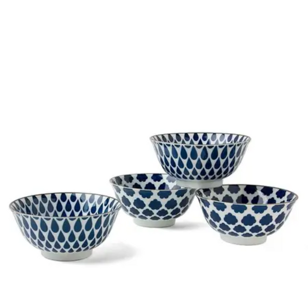 Set of four blue and white patterned bowls on a white background