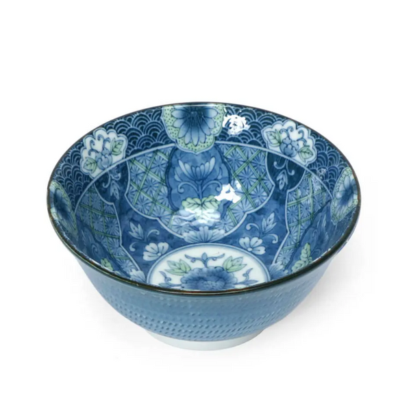 Decorative blue ceramic bowl with intricate patterns on a white background