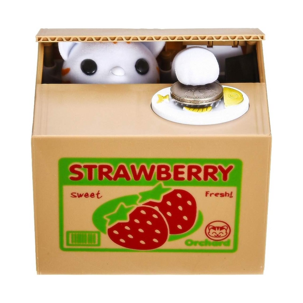 Toy piggy bank with a coin slot and strawberry label on a white background