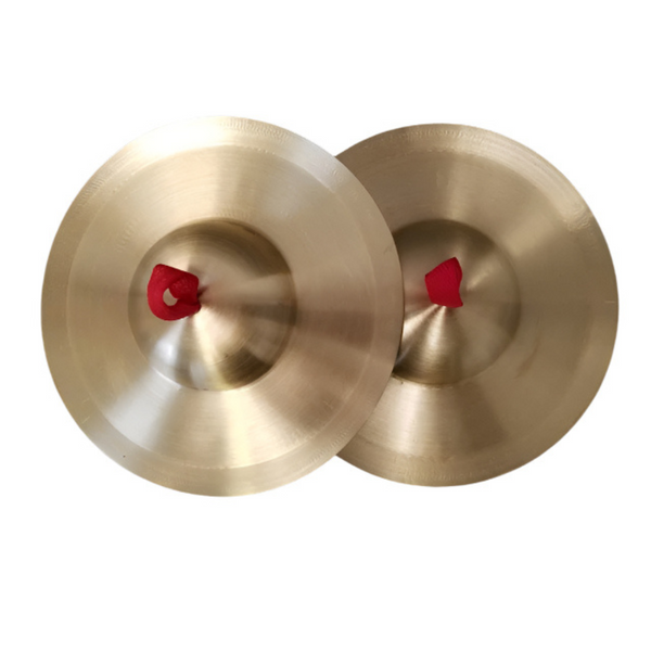 Pair of brass cymbals with red centers on a white background