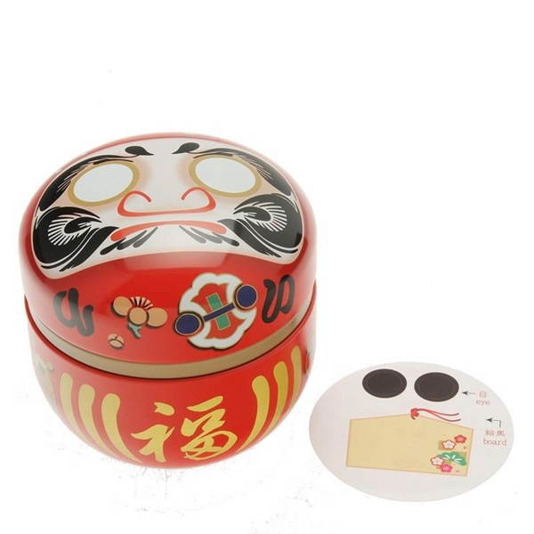 Red daruma doll tea canister with stick on eyes