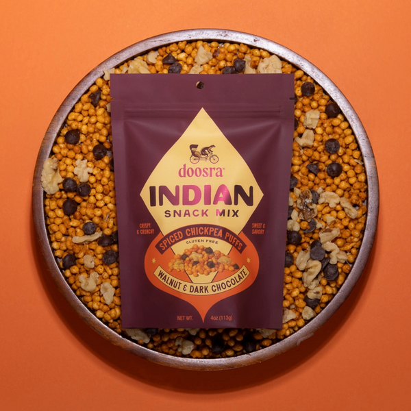 Doosra Indian Snack Mix package on a plate of snack mix against an orange background