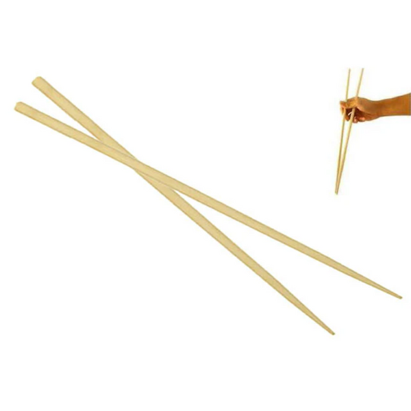 Wooden chopsticks on a white background with a hand holding one pair.