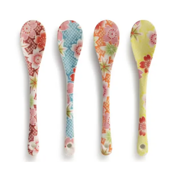 Four floral patterned spoons on a white background