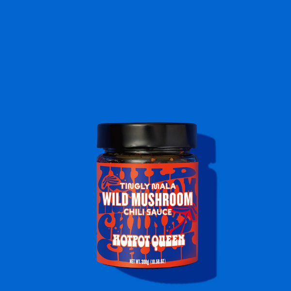 Jar of Wild Mushroom Chili Sauce with red label on blue background