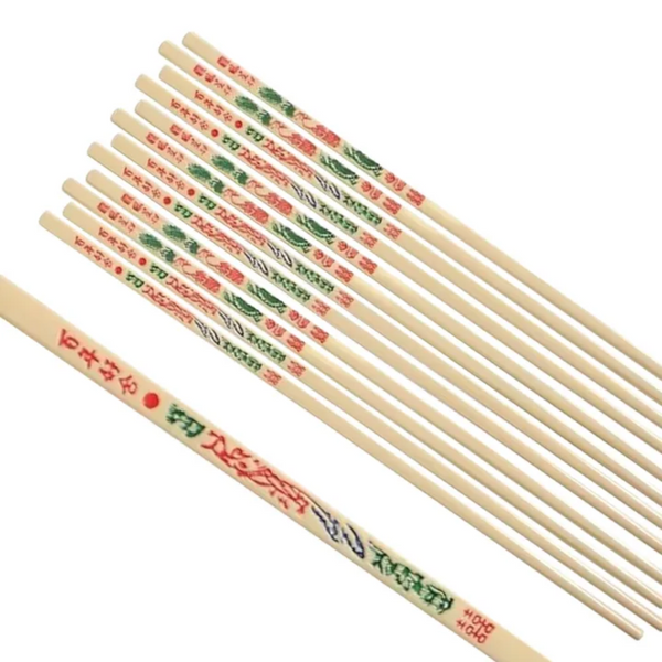 Set of ivory plastic chopsticks with decorative patterns on a white background