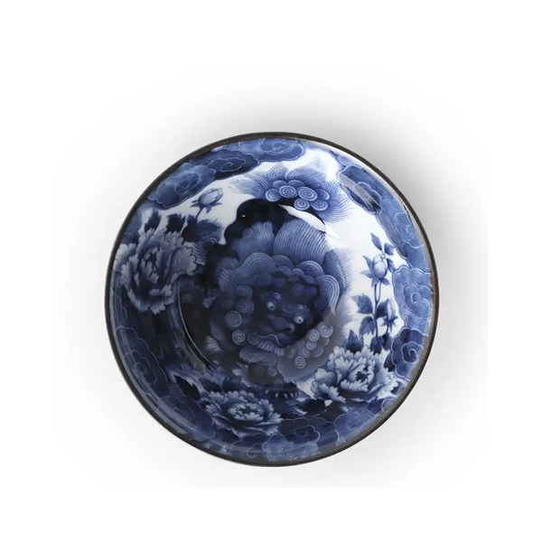 Ceramic bowl with blue floral and fu lion design on a white background