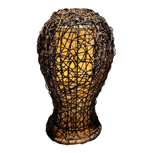 Woven rattan lamp shaped like a head on a white background