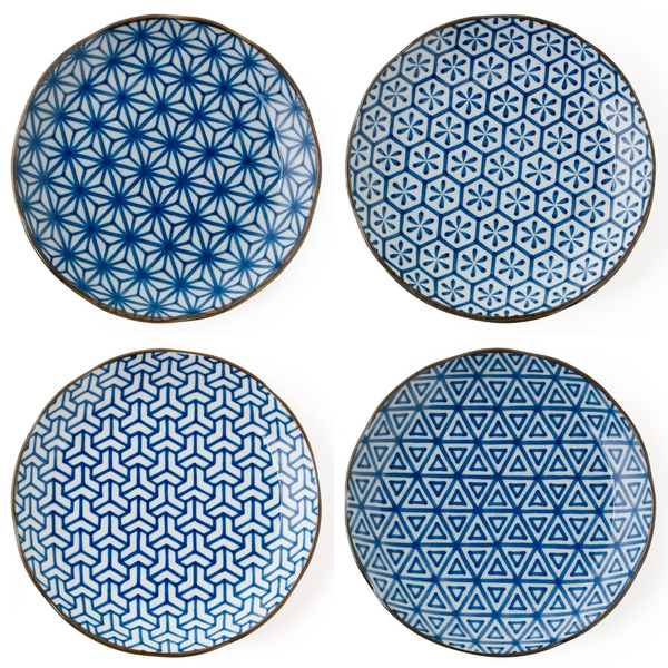 Four blue and white patterned plates on a white background