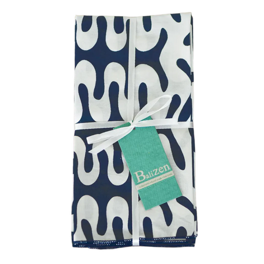 Folded blue and white patterned napkin set with a tag