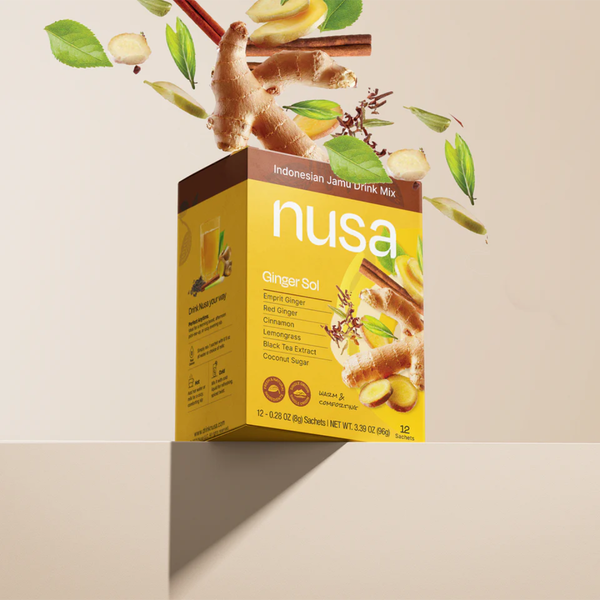 Nusa Indonesian Jamu drink mix box with ginger and cinnamon elements on a beige background