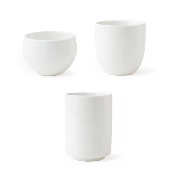 Three white ceramic cups on a white background
