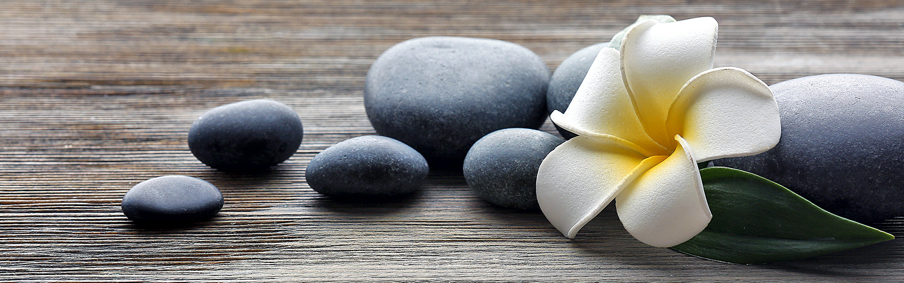 Personal care image with stones and flower