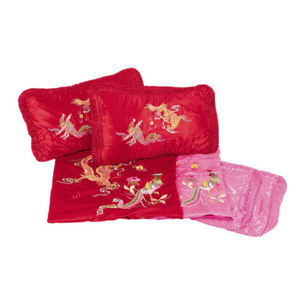 Red pillowcases with dragon-phoenix designs on a white background