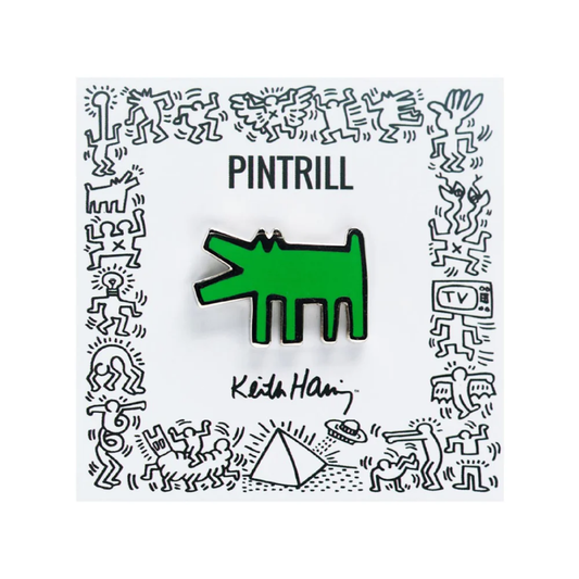 Green dog-shaped enamel pin on a white card with 'PINTRILL' and 'Keith Haring' branding.