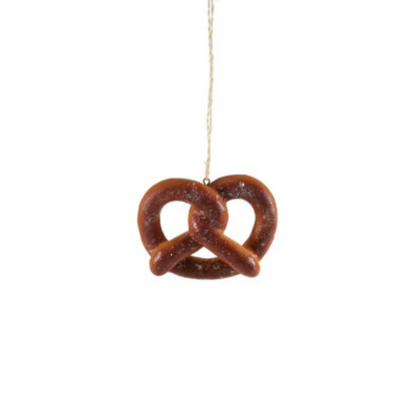 Decorative pretzel ornament hanging on a string against a white background