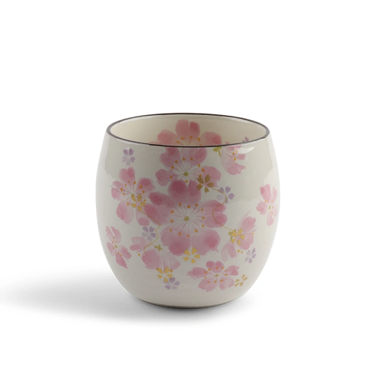 Ceramic cup with floral design on a white background