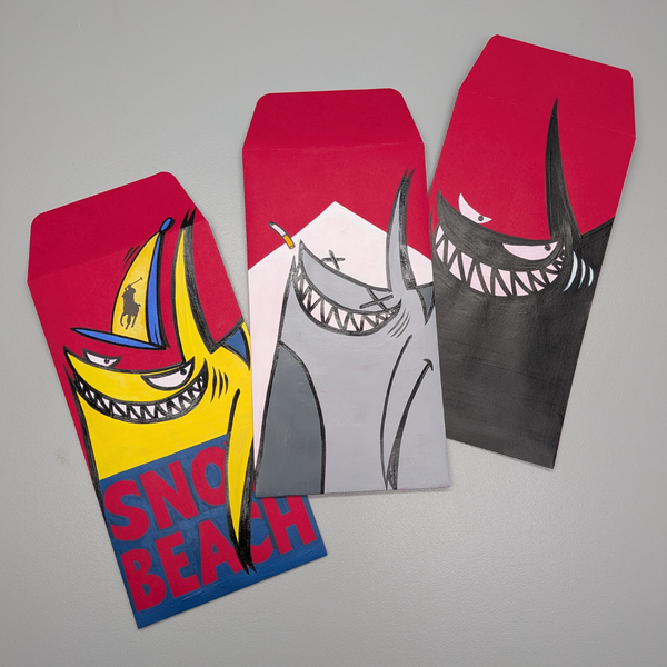 Three colorful envelopes with shark designs on a gray background