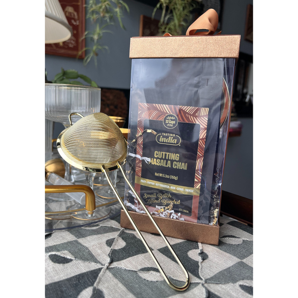 Gift box with bag of Tasting India's Cutting Masala Chai and golden strainer