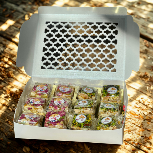 Box of assorted snacks with visible brand logo on a wooden surface