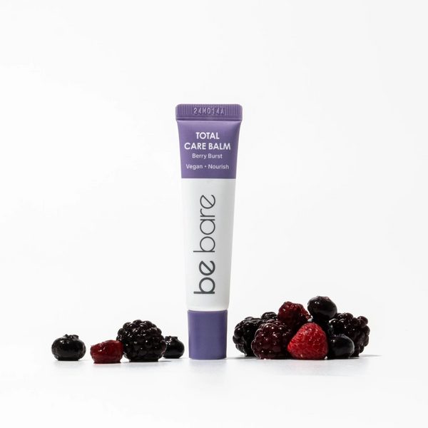 Tube of 'be bare' Total Care Balm with berries on a white background