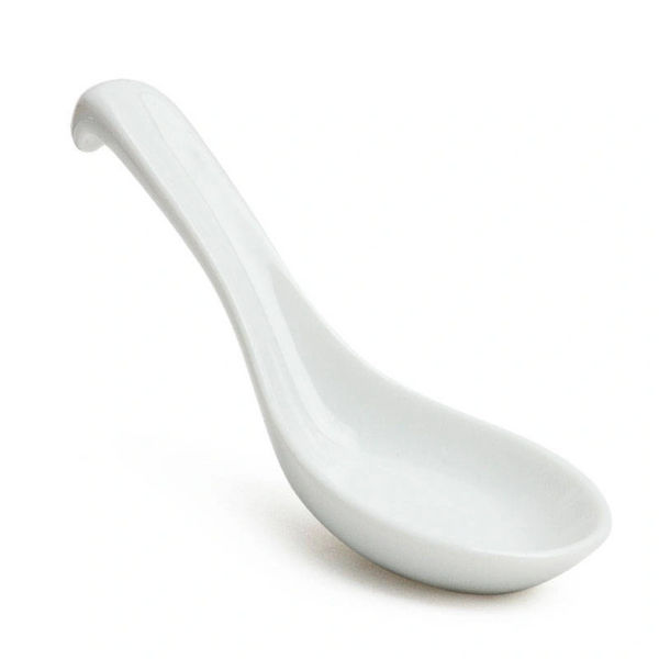 White ceramic soup spoon on a white background