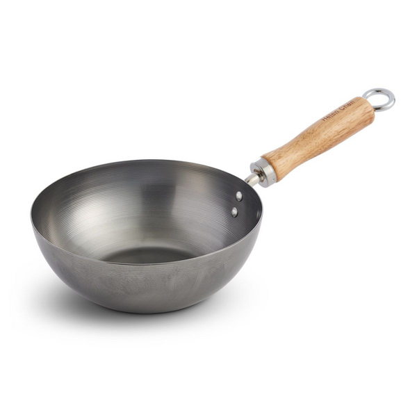 Stainless steel wok with a wooden handle on a white background