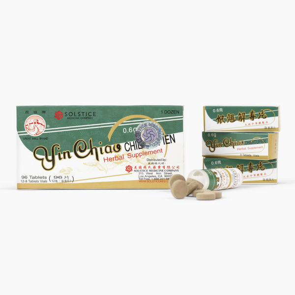 Yin Chiao herbal supplement packaging with pills on a white background