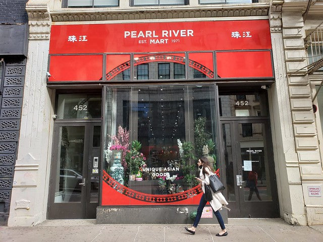 Exterior of Pearl River Mart in Soho with woman walking past