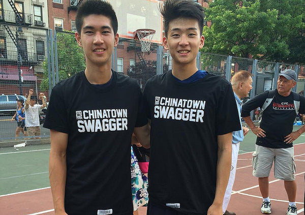 Two young Chinese American men wearing black and white Chinatown Swagger T-shirts 